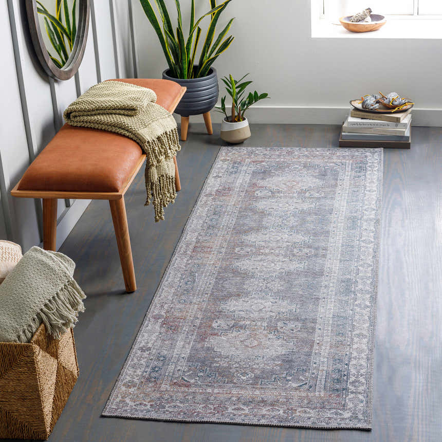Entryway with Baltinglass Gray Washable Rug, brown bench, plants, and gray wood floors. Farmhouse style. Roomscene-Runner