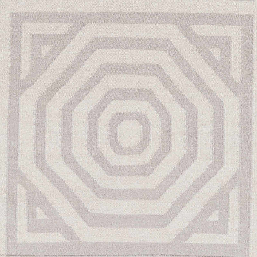 Close-up of the Edmund Area Carpet. Hand-woven wool rug in gray and light gray with a geometric octagon pattern. Swatch