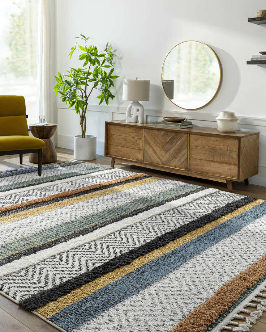 Living room scene with the Edmundston Area Rug. Features a striped design in black, blue, bone, and mustard tones. Farmhouse style. Roomscene-Rectangle