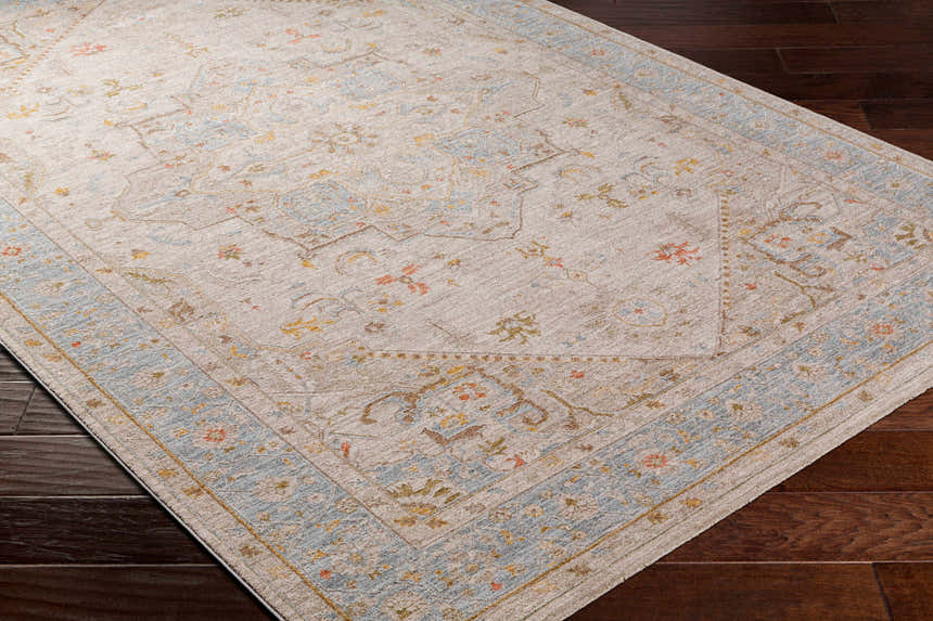Close-up of the Ehan Cream Thick Luxe Oushak Rug showing its traditional pattern, amber, and dusty pink colors. Corner