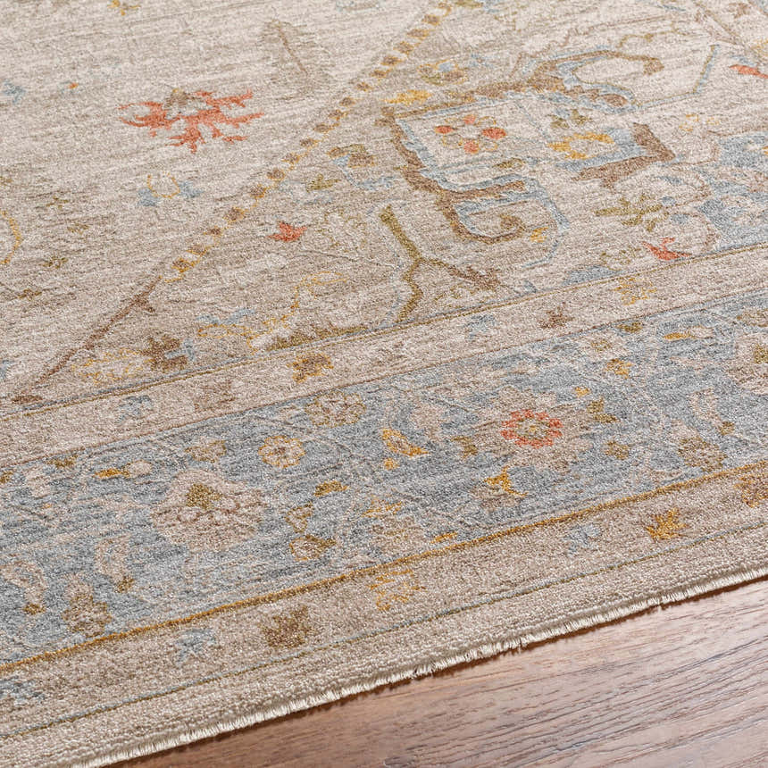 Close-up of the Ehan Cream Thick Luxe Oushak Rug, showing its traditional design, amber, and dusty pink colors. Texture