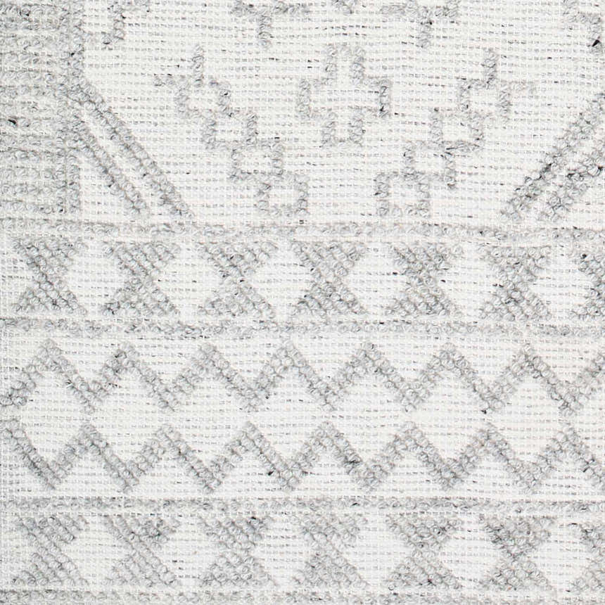 Close-up of the Elin Area Rug showing its hand-woven texture and geometric pattern in arctic stone and dark gray. Swatch