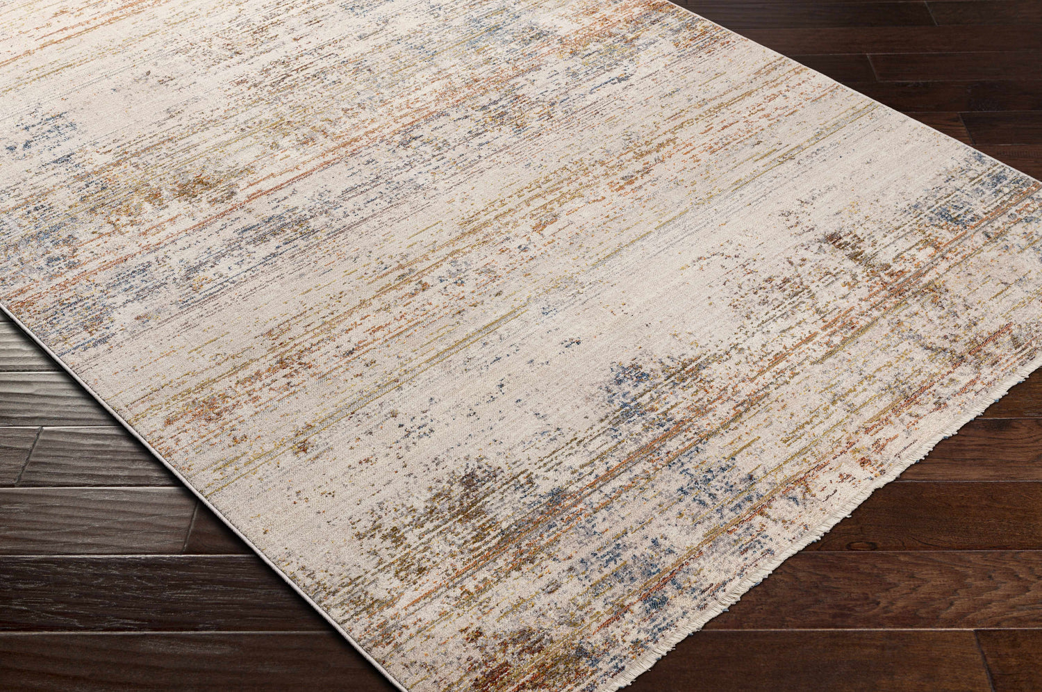 Close-up of the Eltingville Area Rug showing its cream, brick red, blue and orange contemporary design. Corner