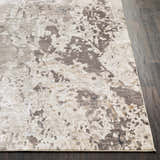 Close-up of the Encinal Area Carpet showing its light beige, brown, and slate contemporary pattern. Front