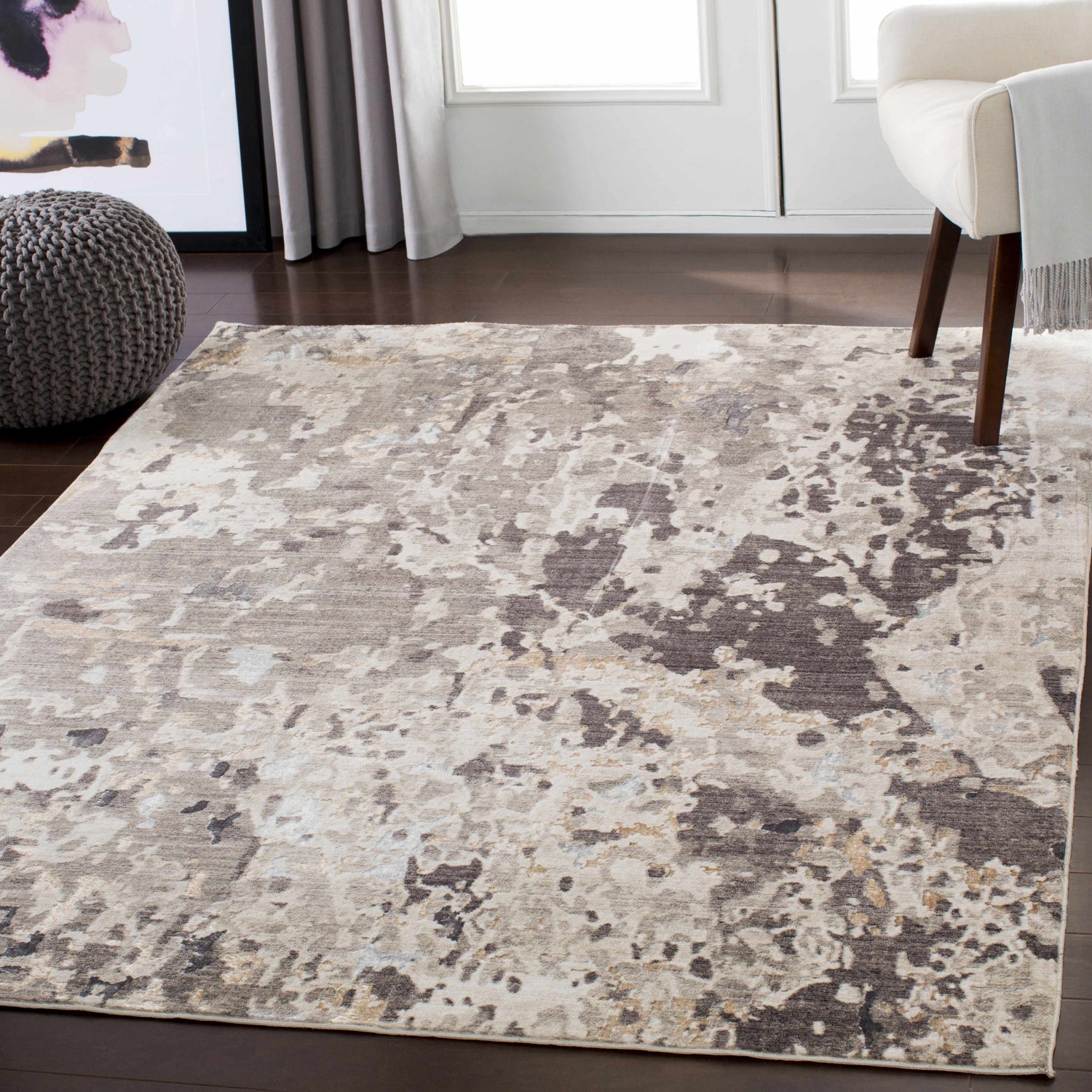 Entryway with Encinal Area Carpet in light beige, brown, and slate. Contemporary rug styled with pouf and chair. Roomscene-Rectangle