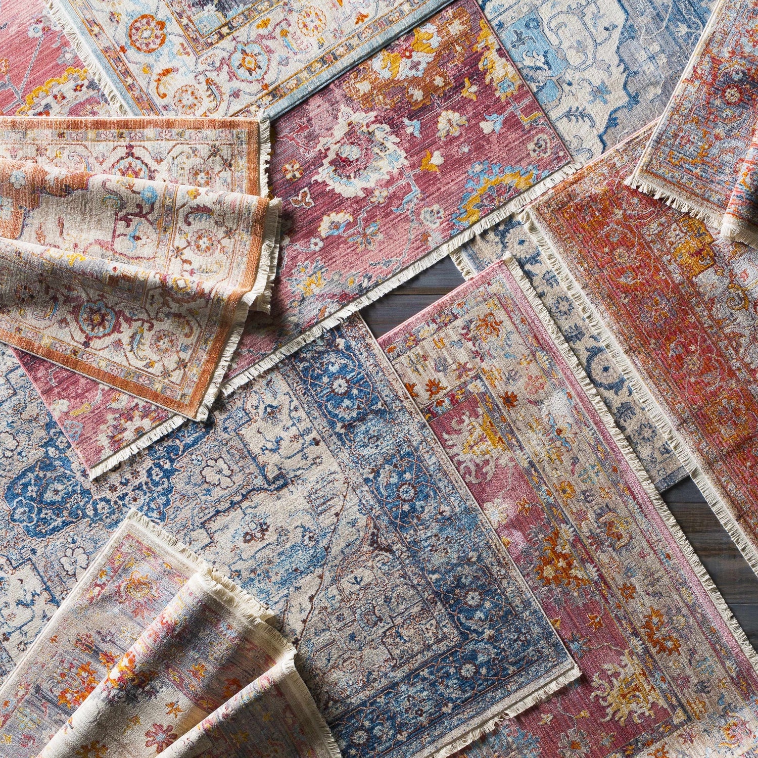 Pile of Stoneboro Area Rugs in various colors and patterns, including bohemian, traditional, and vintage styles. Styleshot