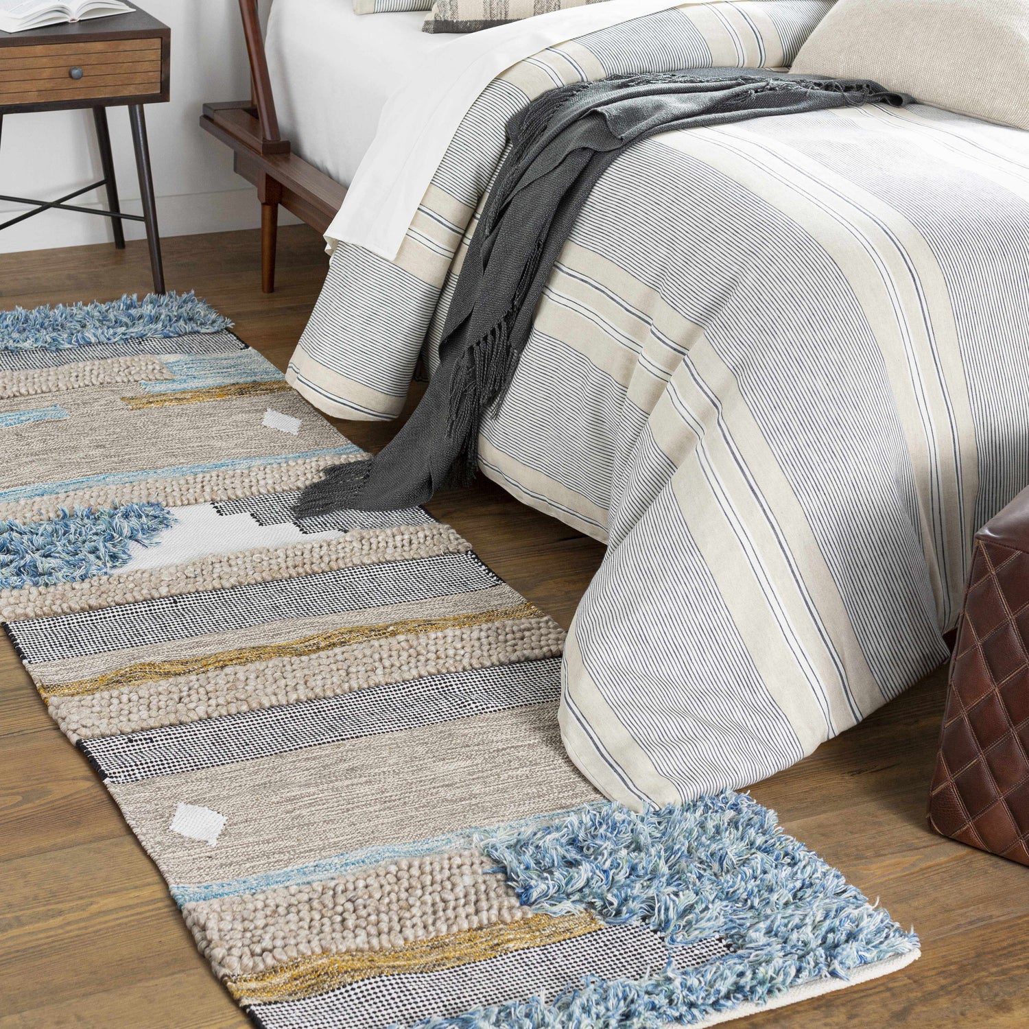 Bedroom scene with striped bedding and the Ephraim Carpet runner with blue fringe detail. Roomscene-Runner