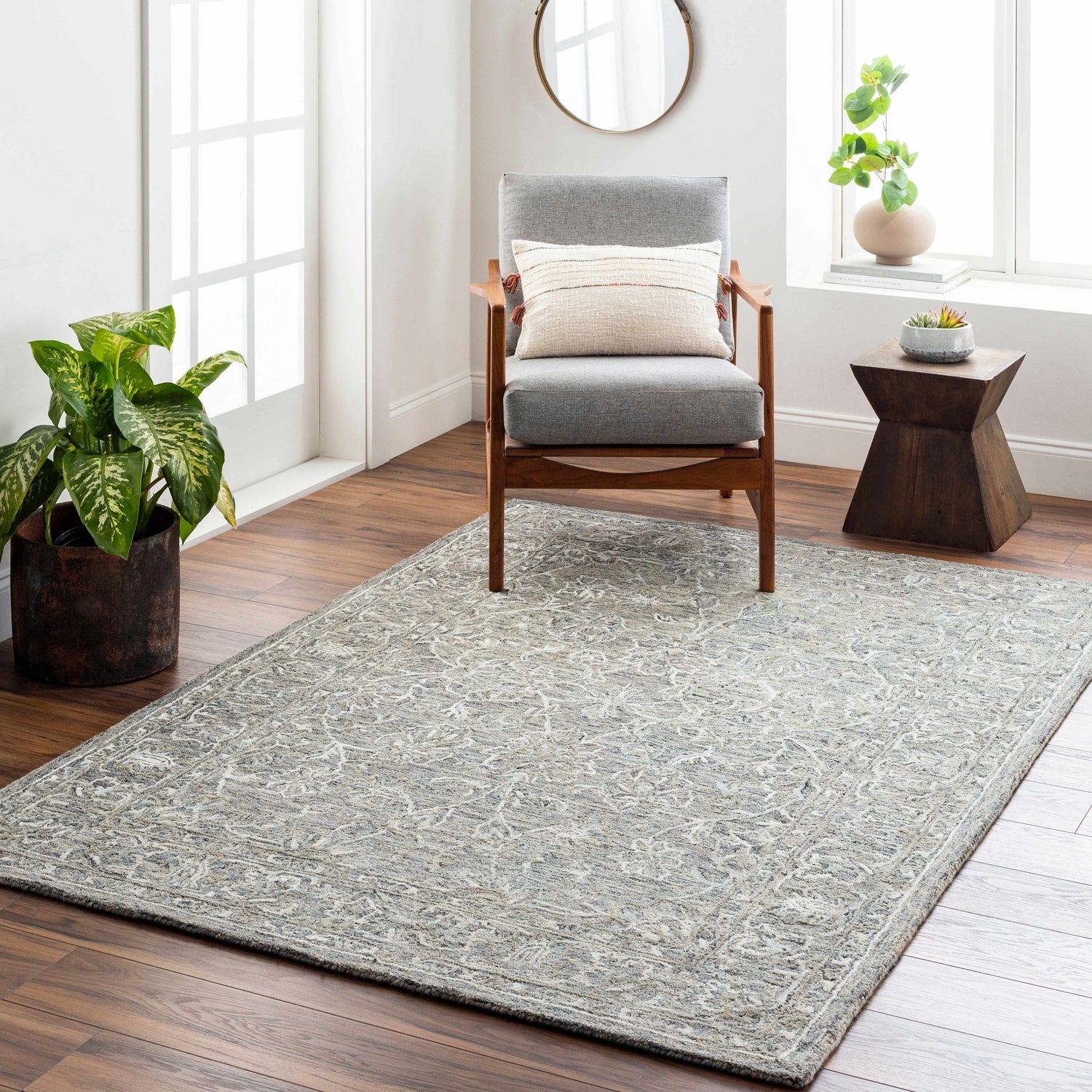Living room scene with Eriline Wool & Faux Silk Rug in denim and ivory, gray chair, wood floors, and natural light. Roomscene-Rectangle