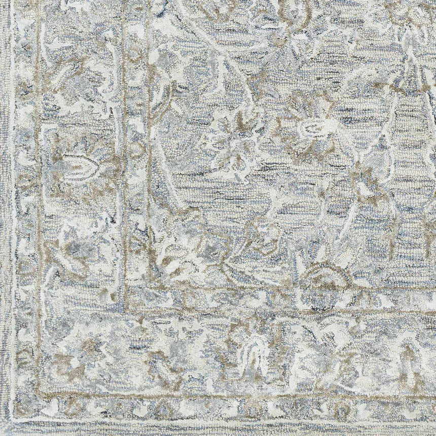 Close up of the Eriline Wool & Faux Silk Rug. Denim, ivory, sage, and taupe tones create an oriental pattern. Hand-tufted texture. Swatch