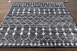 Close-up of Erina Premium Rug - Clearance. Hand-knotted rug with a black, charcoal, and cream geometric pattern. Front