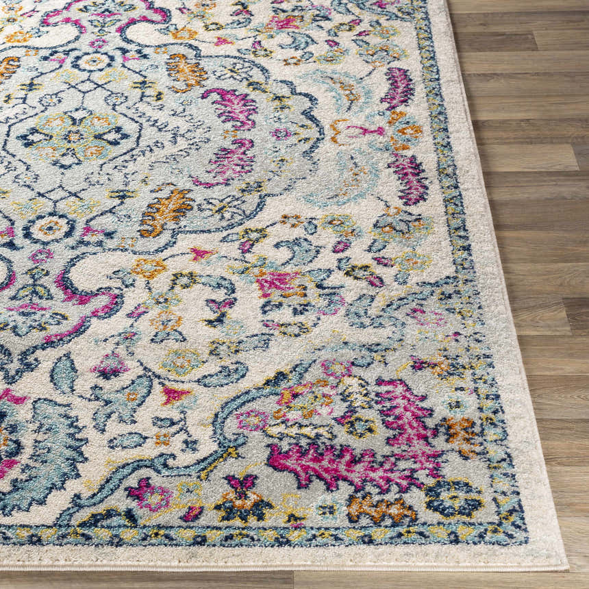 Close up of the Errol Area Rug showing its aqua, pink, and burnt orange floral pattern on a light background. Front
