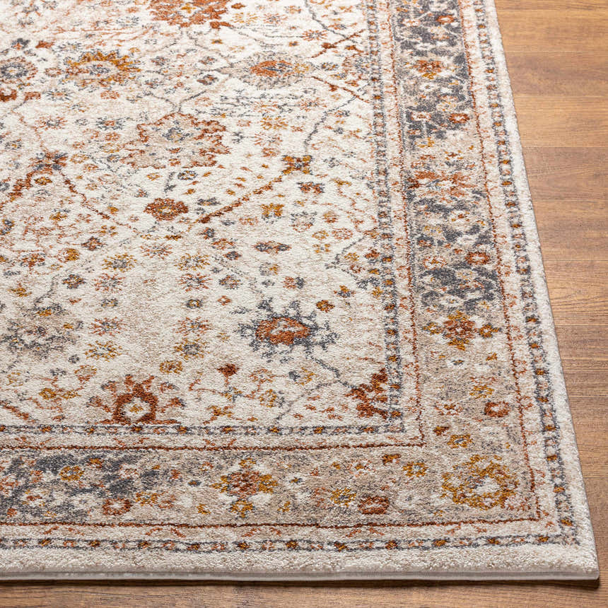 Close up of the Paatan Luxe Floral Oushaq Area Rug showing cream, gold, brown, and gray floral design and border. Front