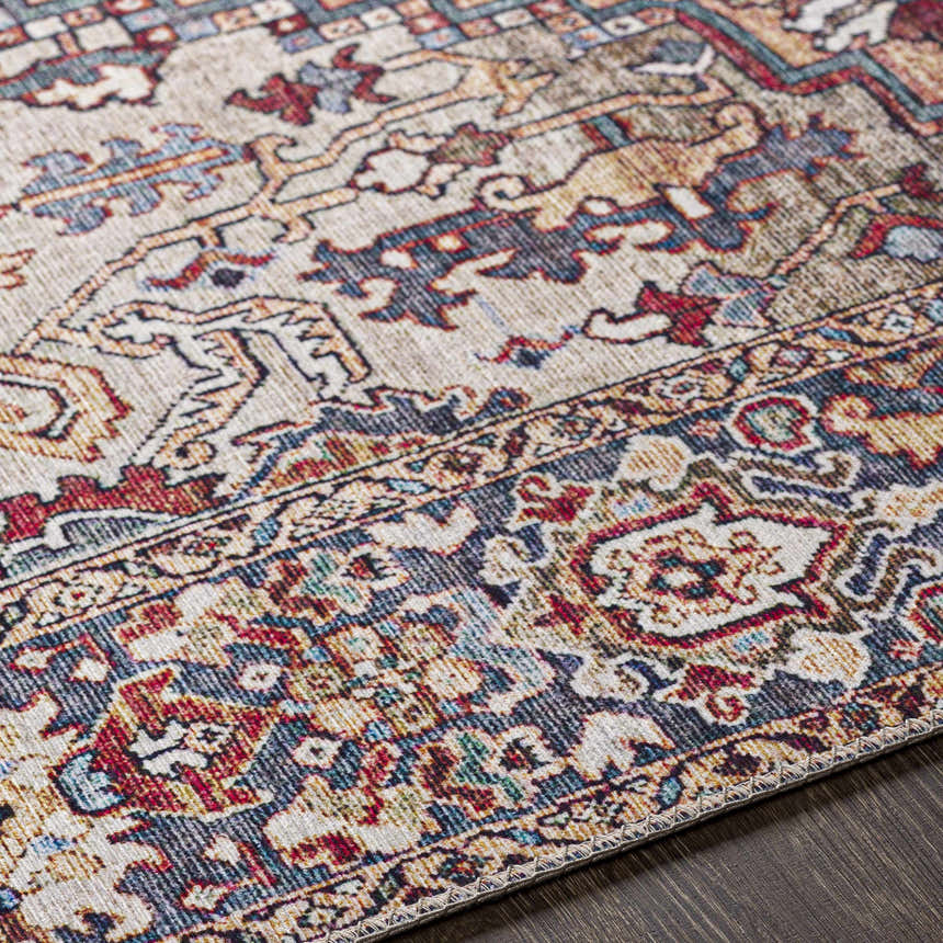 Close up of the Neyland Iris Area Rug, a beige rug with brick red, navy, and olive traditional patterns. Texture