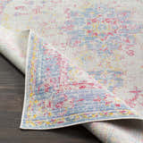 Close-up of the Eufaula Area Rug featuring a vintage-inspired design with burgundy, gray, lavender, and yellow hues. Fold