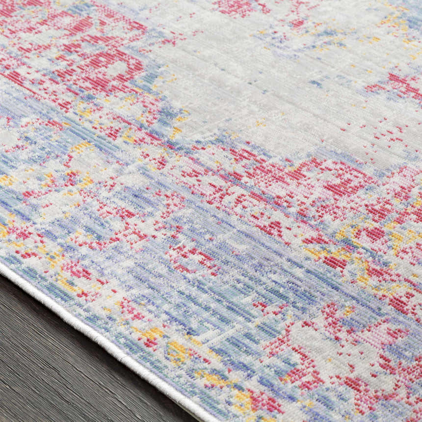 Close-up of the Eufaula Area Rug showing its burgundy, gray, lavender, and yellow bohemian pattern. Texture