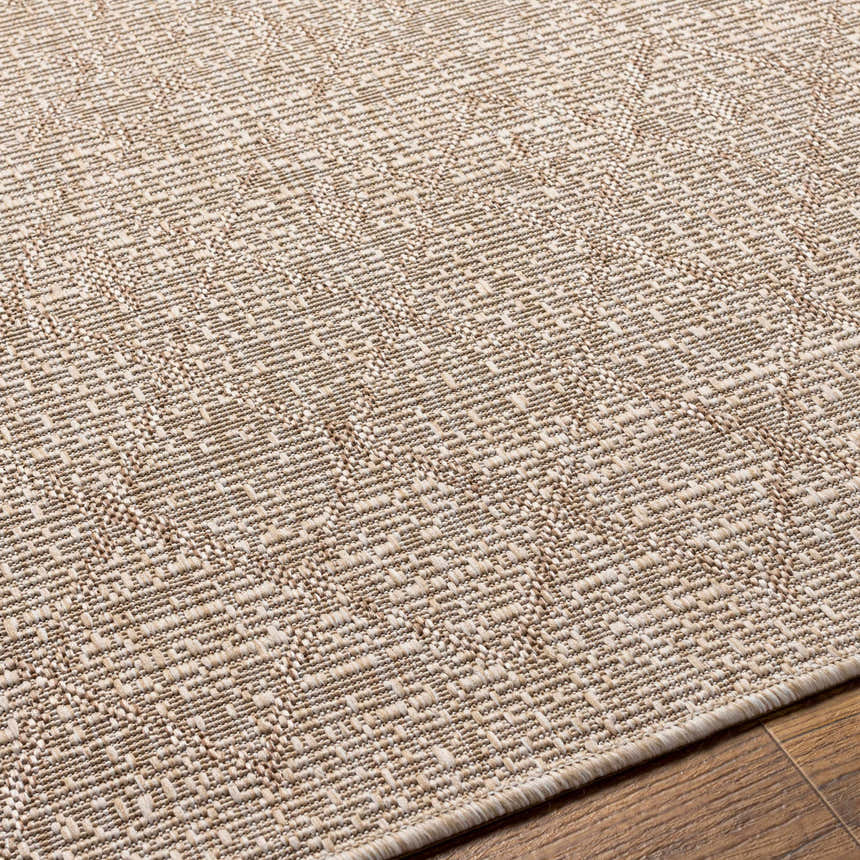 Close-up of the Maunawili Cream Nordic Rug showing the woven texture and geometric pattern in beige and light brown tones. Texture