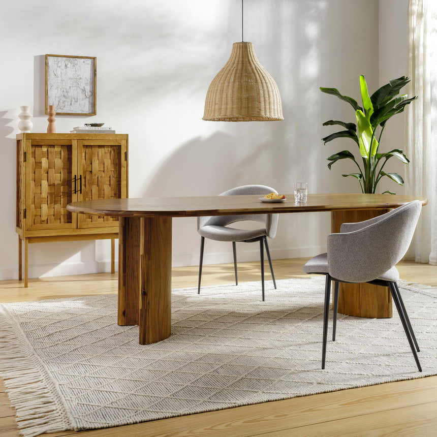 Dining room scene with a bone and gray Ezria Wool Rug, wood table, gray chairs, and woven pendant light. Roomscene-Rectangle