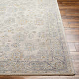 Close-up of the Coby Sage Avant Garde rug showing its traditional pattern, teal, brown, and gray colors, and soft texture. Front