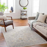 Living room with beige sofa and Coby Sage Avant Garde rug. Farmhouse style with wood floors, gray chair, and natural light. Roomscene-Rectangle