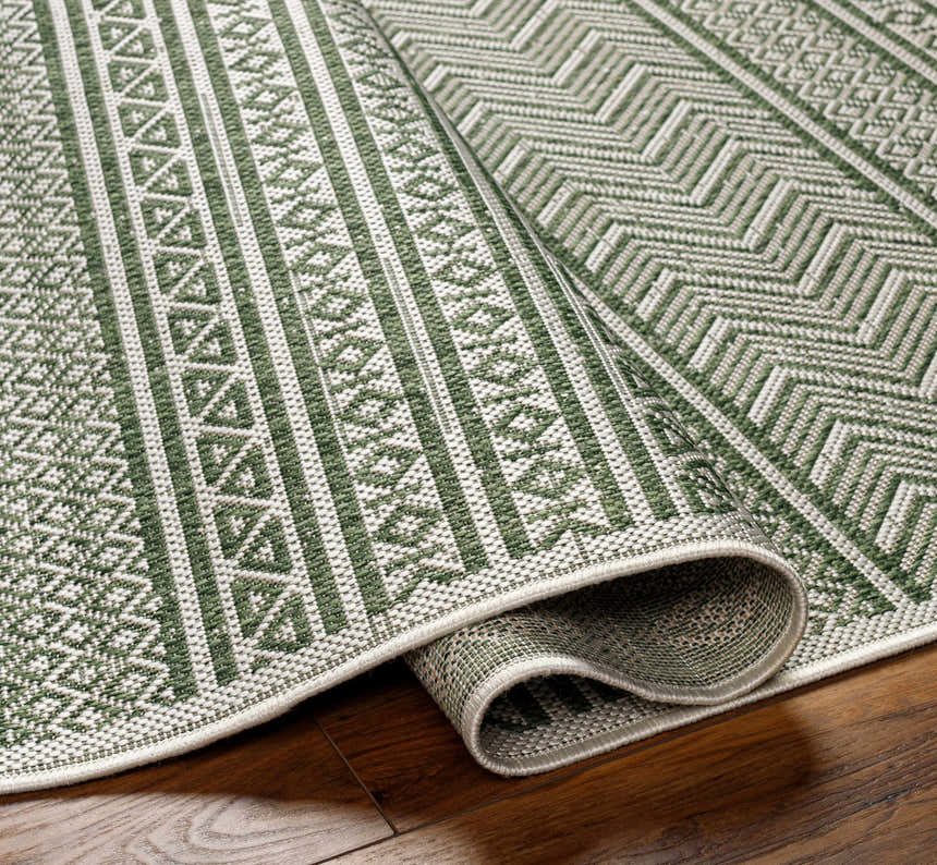 Close-up of the Madras Natural Gray Green All Over Performance Area Rug showing its green and gray geometric pattern. Fold