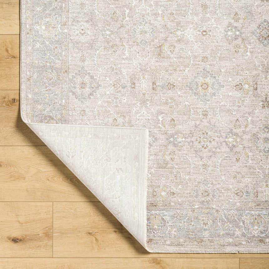 Close-up of the Feray Thick Luxe Area Rug showing its traditional floral pattern and colors on a wood floor. Fold
