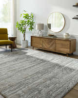 Living room scene with a gray and ivory Ferrelview Area Rug, wood console table, round mirror, and chartreuse chair. Roomscene-Rectangle