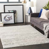 Living room scene with a gray sofa and the Ferrelview Area Rug in gray and ivory. Roomscene-Rectangle