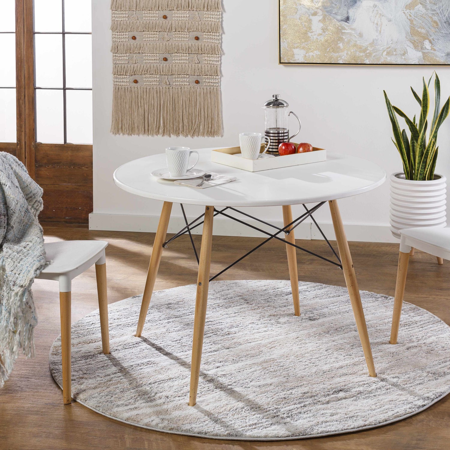 Dining room scene with round white table on gray and ivory Ferrelview Area Rug. Roomscene-Round
