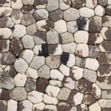 Close-up of the hand woven Fillmore Area Carpet. Wool rug features black, charcoal, cream, and gray tones. Texture