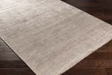 Close-up of Fochabers Premium Area Rug in black and gray, showing its subtle contemporary pattern and soft texture on dark wood floors. Corner