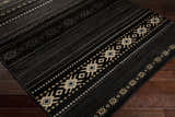 Close-up of the Fogertown Black Western Rug. Features a black base with beige, gray, and tan Southwestern-inspired geometric patterns. Corner