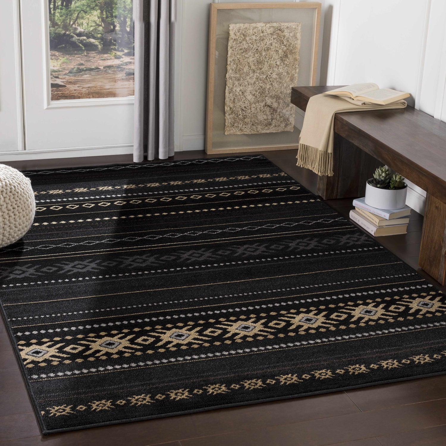 Entryway with a Fogertown Black Western Rug, dark wood floors, bench, and neutral accents. Roomscene-Rectangle