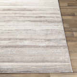 Close-up of Fombell Abstract Striped Area Rug. Charcoal, gray, tan, and white stripes on a soft, textured surface. Front