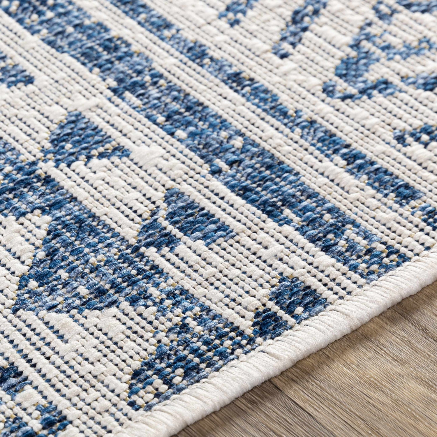 Close-up of the Novato Navy All Over Pattern Performance Rug showing blue and white geometric design and texture. Texture