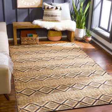 Living room scene with tan sofa and Foxrock Jute Carpet in black and tan geometric design. Bohemian farmhouse style. Roomscene-Rectangle