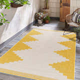 Patio scene with a yellow and beige geometric Djugun Yellow Outdoor Rug on a gray wood floor. Roomscene-Rectangle