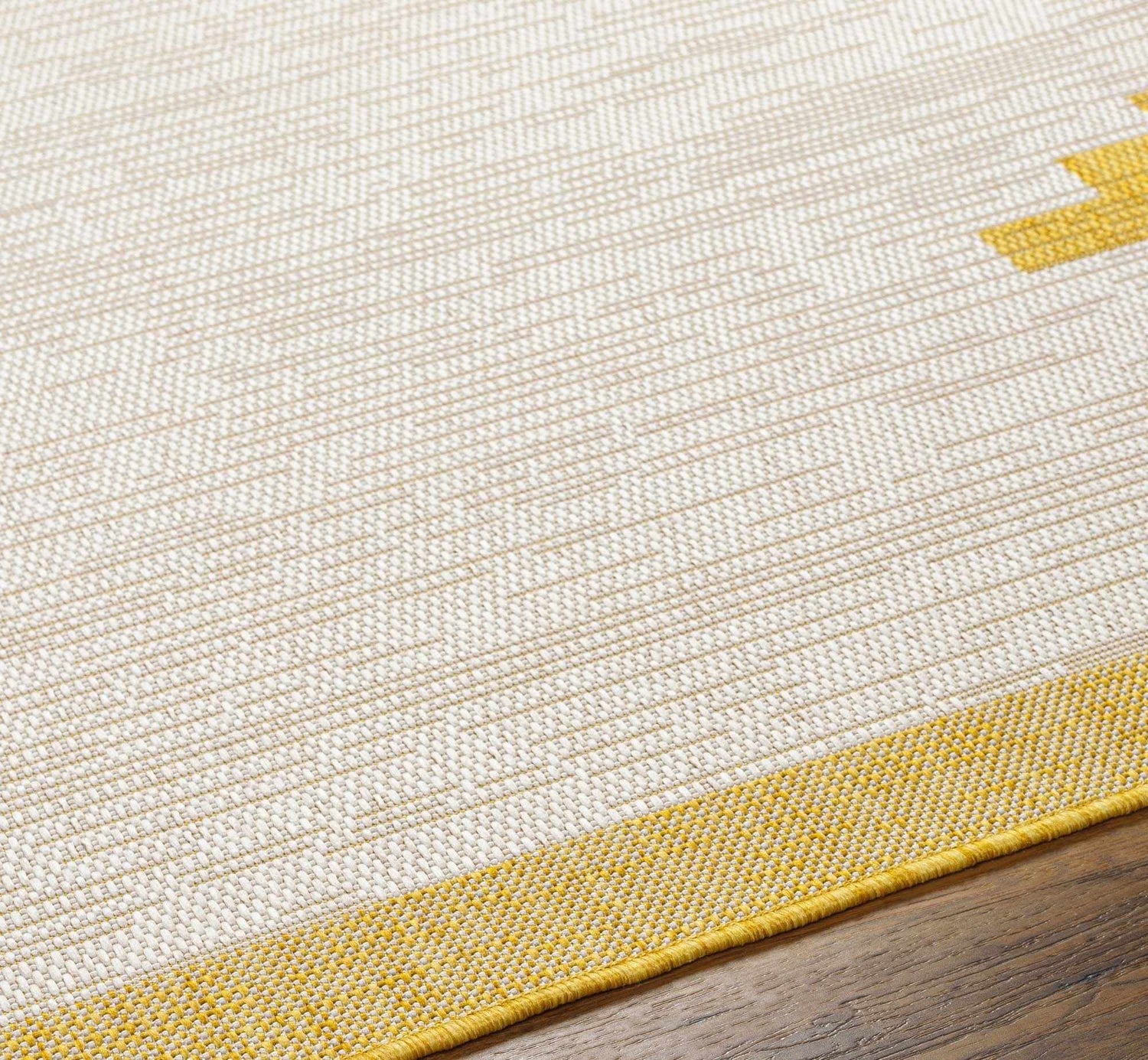 Close-up of Djugun Yellow Outdoor Rug showing beige, bone, and yellow geometric pattern and woven texture. Texture