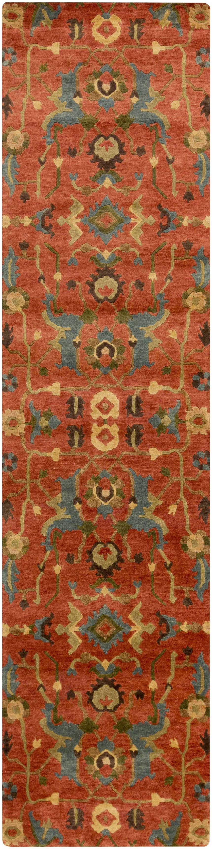 Close-up of the Frederica Area Rug, a hand-knotted runner with a brick red background and botanical pattern in blue, green, and brown. Design-Runner-2610