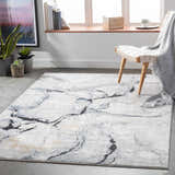 Bright living room scene featuring the Fremantle Gray Marble Rug with a cream chair and gray throw. Roomscene-Rectangle