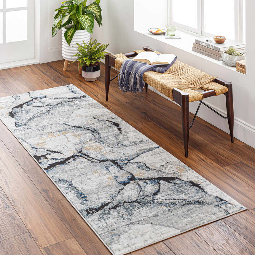 Entryway with a Fremantle Gray Marble Rug, wood floors, and a woven bench by a window. Roomscene-Runner