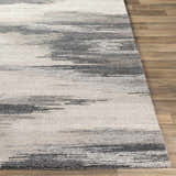 Close-up of the Farnhamville Area Carpet. Hand-tufted wool rug with a contemporary abstract pattern in gray, beige, and ivory. Front