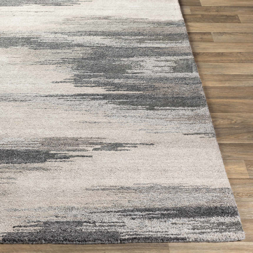 Close-up of the Farnhamville Area Carpet. Hand-tufted wool rug with a contemporary abstract pattern in gray, beige, and ivory. Front