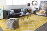 Living room scene with a mustard Bloomer Area Rug, gray sofa, wood furniture, and pops of blue and yellow accents. Roomscene-Rectangle