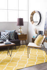 Living room scene with a mustard Bloomer Area Rug, gray sofa, and mid-century modern furniture. Roomscene-Rectangle