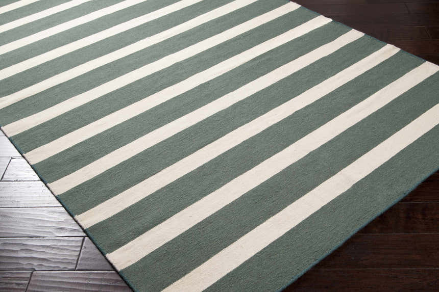 Close-up of the Galliano Area Carpet. Dark green and light beige stripes on a hand woven wool rug. Corner
