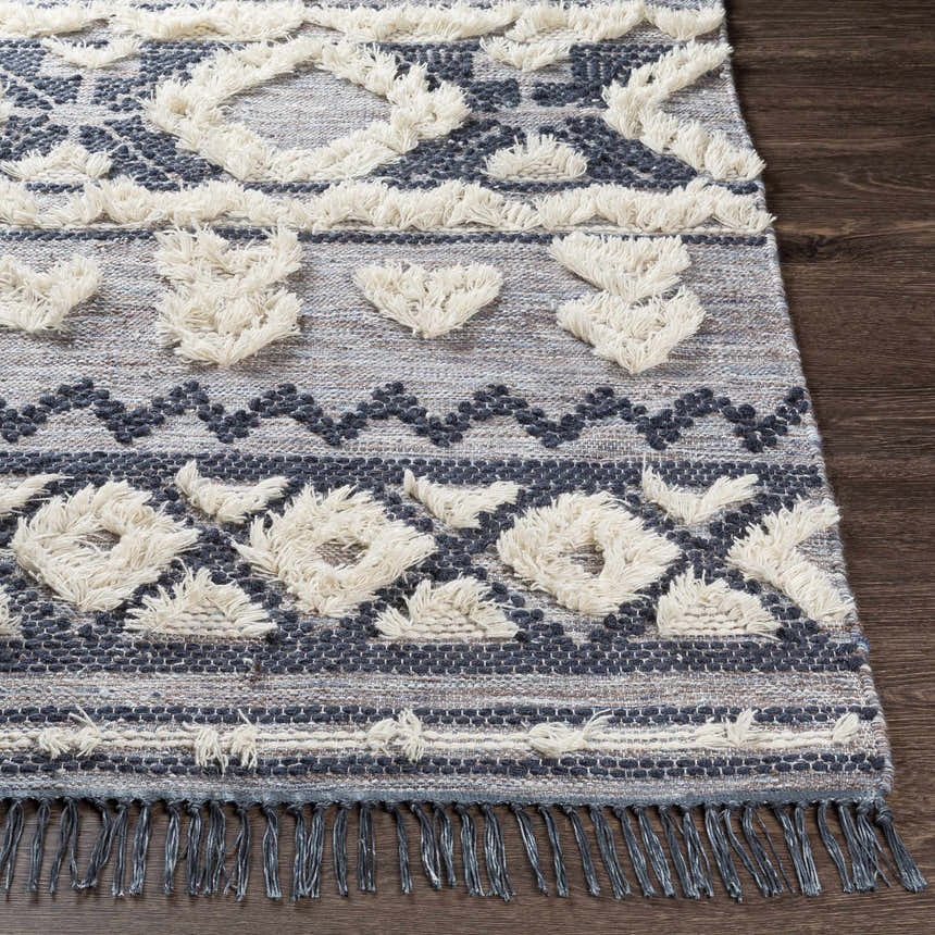 Close-up of Gakona High-Low Cream&Blue Wool Rug showing texture, fringe, and bohemian-inspired geometric pattern. Front