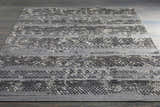 Embossed Galchutt Gray Rug: A hand-loomed viscose and wool rug with charcoal, gray, and light gray geometric patterns. Styleshot