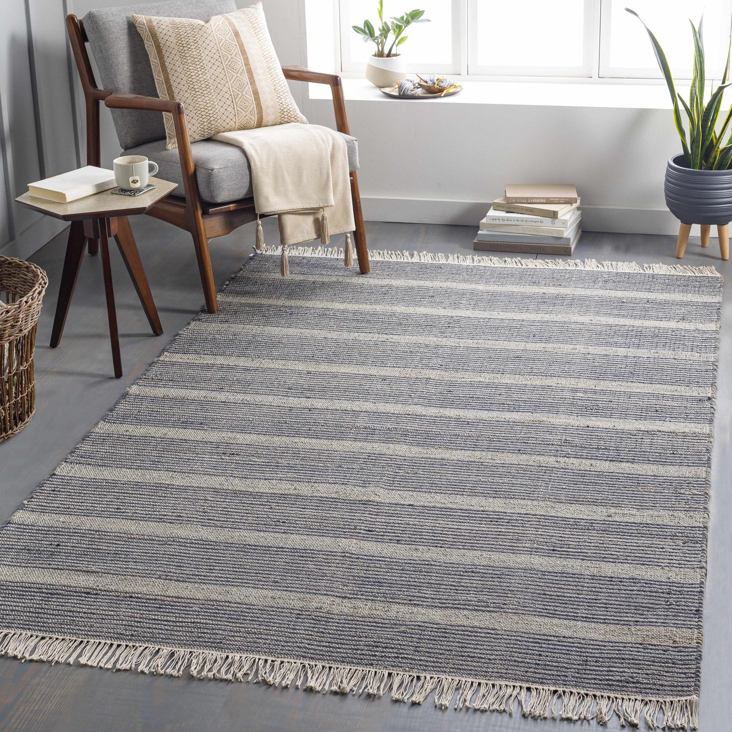 Living room scene with navy and off-white striped Gambalidio Area Rug, gray chair, side table, and plants. Roomscene-Rectangle