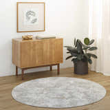 Minimalist room scene with round Ganit Thick Luxe Boutique Rug in beige, bone, and gray tones. Roomscene-Round