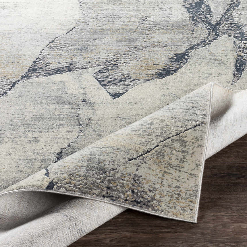 Close-up of the Gasquet Gray Marble Textured Luxe Rug, showing charcoal, blue, and gray tones and soft, luxe texture. Fold